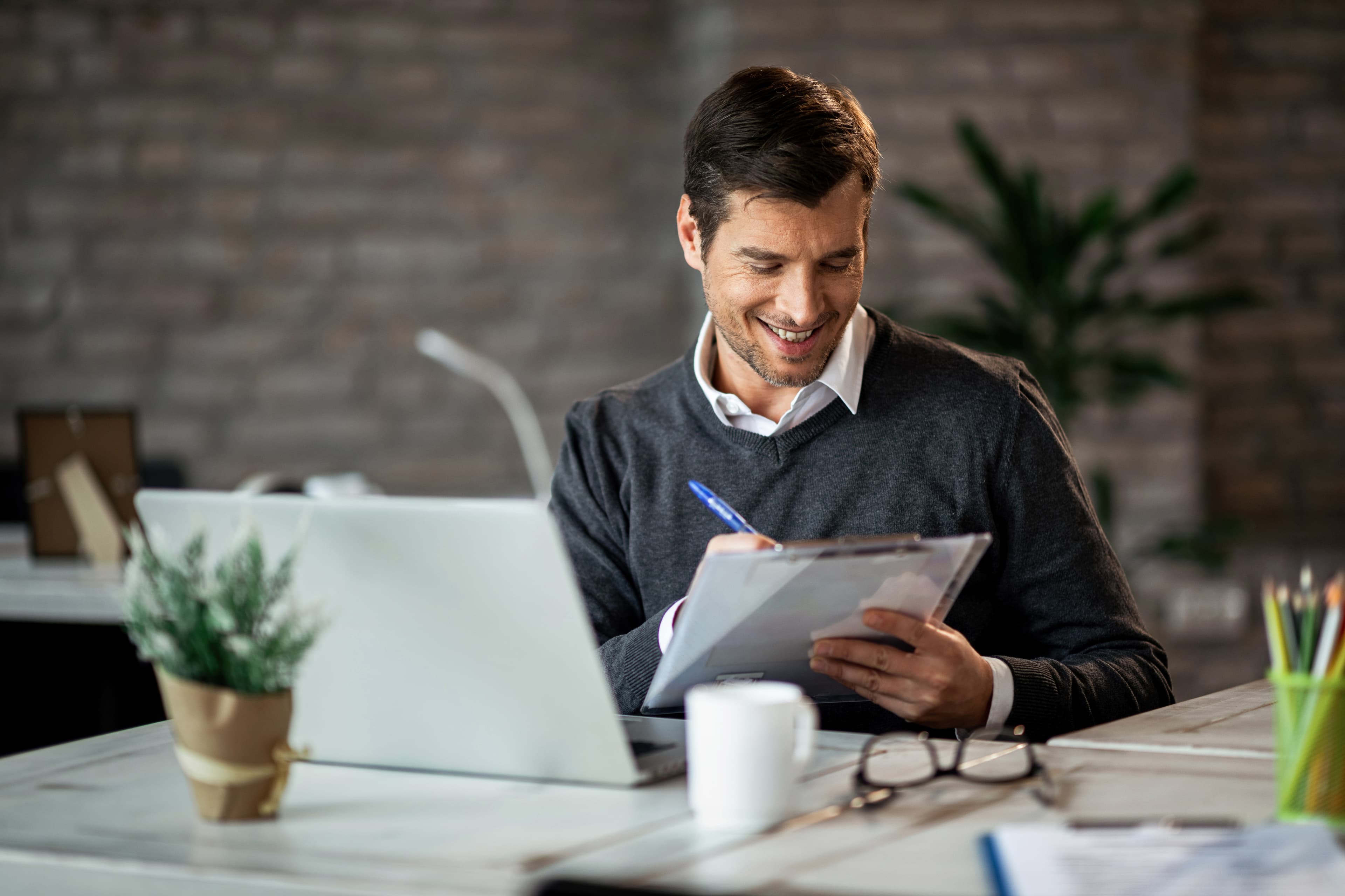 An investor reviewing project documents at their desk
