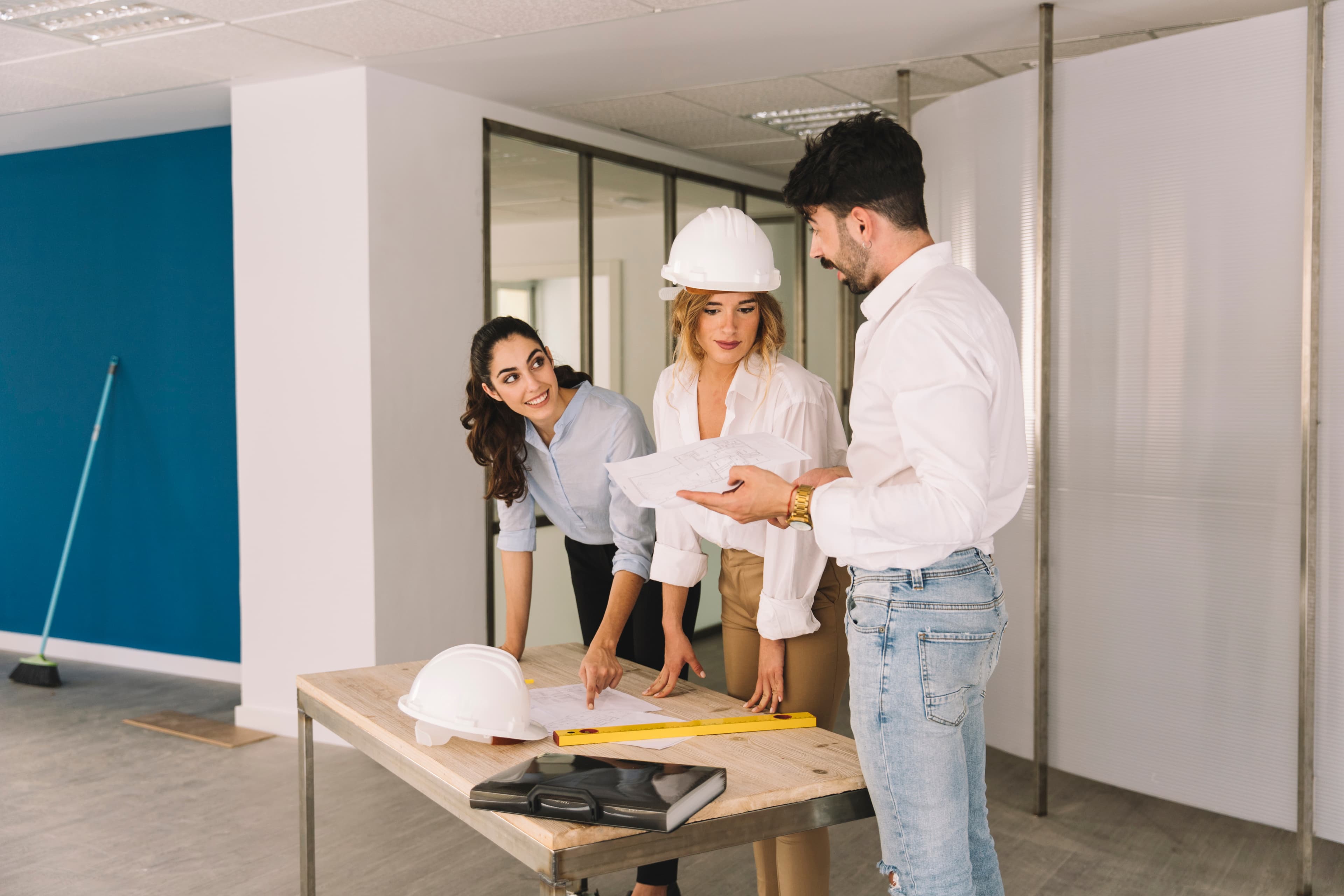 A site team reviewing plans on a table